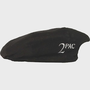 May include: Black beret with the embroidered text "2PAC" in white. The hat is made of a soft fabric and has a classic, casual style. The beret is a versatile accessory.