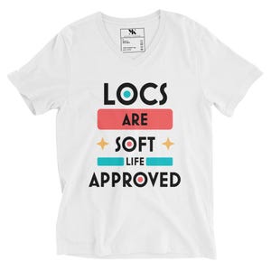 May include: White V-neck t-shirt with the text "LOCS ARE SOFT LIFE APPROVED" in black and colorful accents.
