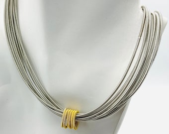 Piano wire  multi strand and gold coils  necklace
