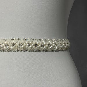 Full view of the bridal belt, highlighting its graceful design and shimmering details. A stunning addition to any wedding dress for a touch of timeless beauty.