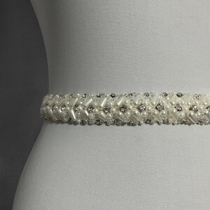 Close-up of the handcrafted bridal belt, showcasing intricate beadwork with sparkling crystals and pearls. A perfect blend of elegance and sophistication for your special day.