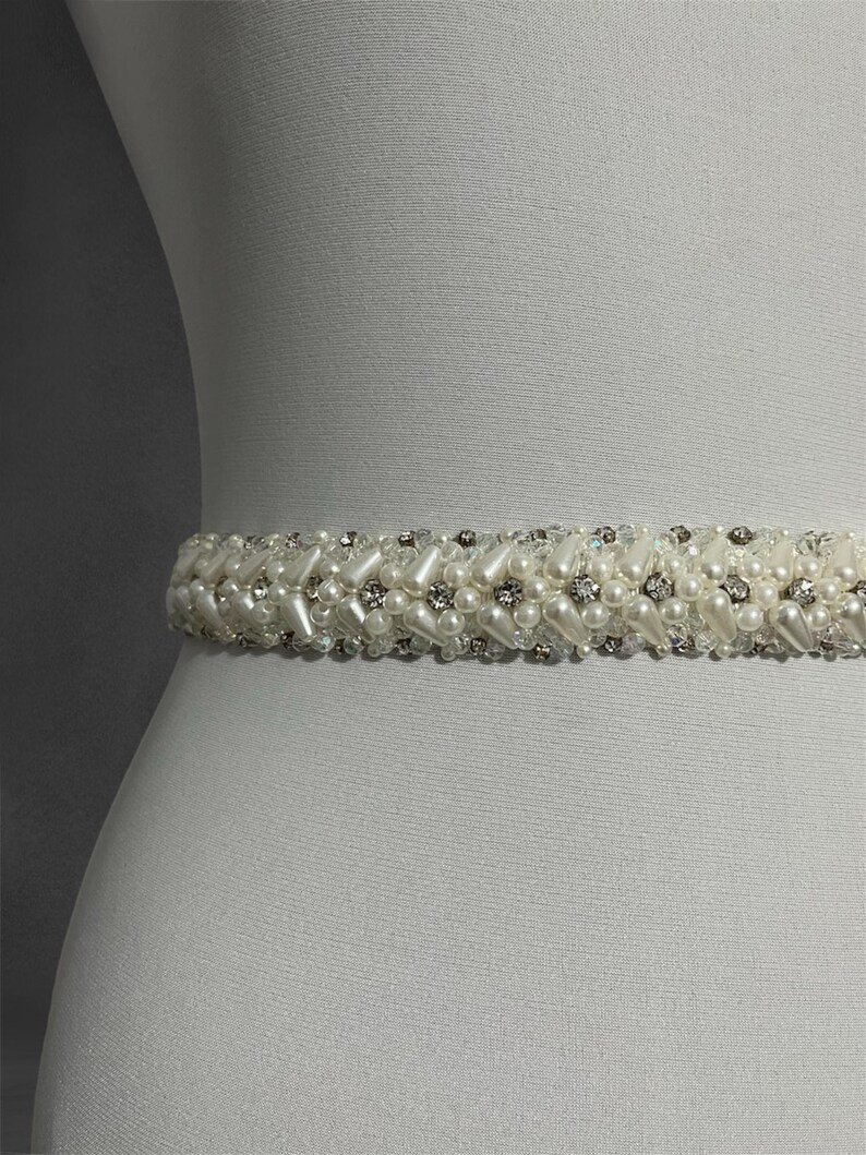 Close-up of the handcrafted bridal belt, showcasing intricate beadwork with sparkling crystals and pearls. A perfect blend of elegance and sophistication for your special day.