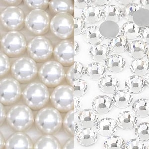 May include: Close-up of two distinct textures: lustrous white pearls and sparkling clear rhinestones. The pearls are arranged in a grid pattern, while the rhinestones are scattered, showcasing their facets. Ideal for jewelry making and crafts.
