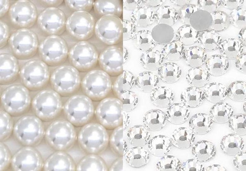 May include: Close-up of two distinct textures: lustrous white pearls and sparkling clear rhinestones. The pearls are arranged in a grid pattern, while the rhinestones are scattered, showcasing their facets. Ideal for jewelry making and crafts.