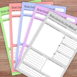 May include: A stack of colorful Brain Dump for the Week of planner sheets. Each sheet has sections for goals, a dump zone, and notes. The sheets are in shades of green, pink, blue, purple, and gray.
