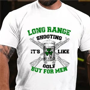 May include: White t-shirt with a green shamrock and the text "Long Range Shooting It's Like Golf But For Men".