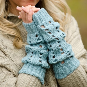 May include: A pair of light blue crocheted fingerless gloves with a lacy pattern.