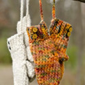 May include: Two pairs of crocheted mittens hanging on a tree branch. One pair is beige and the other is a multi-colored mix of orange, yellow, and brown.