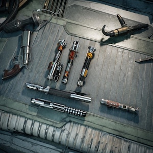 May include: A collection of various lightsabers and a blaster pistol are displayed on a metallic surface. The lightsabers feature diverse designs with silver, black, and red accents. The pistol has a silver body and a brown grip.