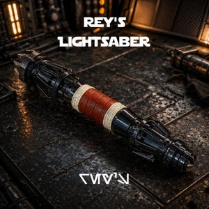 May include: A black and silver lightsaber with a red and tan grip. The text "REY'S LIGHTSABER" is displayed above the lightsaber. The lightsaber is on a dark, textured surface. The text "REY'S" is displayed below the lightsaber.