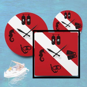 May include: Three decorative clocks with a scuba diving theme. The clocks are red with a white diagonal stripe and black accents. Each clock features a seahorse, scuba tank, dive mask, and fins. The clocks are round and square with black clock hands.