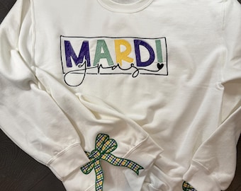 Mardi Gras embroidered sweatshirt .Available with cut out detail on sides.