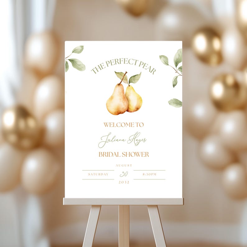 May include: A white sign on an easel with the text "THE PERFECT PEAR" and "WELCOME TO Juliana Hayes BRIDAL SHOWER". The sign features watercolor illustrations of pears and leaves, with event details.