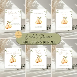 May include: A bundle of bridal shower table signs. Each sign features watercolor pears and greenery. The signs include phrases like "Strike a Pose," "Welcome," "Mimosa Bar," "Guest Book," "Love is Sweet," and "Share the Love."