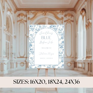 May include: A white sign with blue floral accents and the text "Something Blue Before I Do." The sign welcomes guests to a bridal shower and lists the sizes: 16x20, 18x24, and 24x36 inches. It is displayed on a wooden easel.