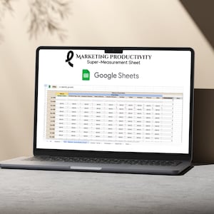 May include: A laptop computer displaying a Google Sheets spreadsheet titled "Marketing Productivity Super-Measurement Sheet". The spreadsheet contains columns for various marketing metrics, such as website traffic, social media engagement, and email marketing results.