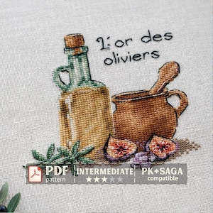 May include: Cross-stitch design featuring a bottle, a pot with a spoon, figs, and olive branches. The text "L'or des oliviers" is above the pot. The design is labeled "PDF pattern" and "Intermediate".