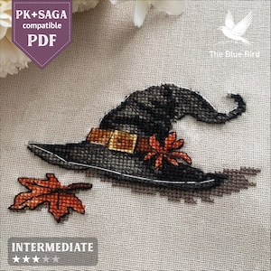 May include: Cross-stitch pattern featuring a black witch's hat with a gold buckle and a red flower, along with an orange leaf. The text "PK+SAGA compatible PDF" and "INTERMEDIATE" are also visible.