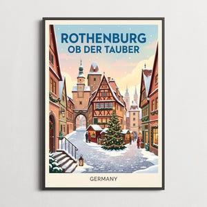 May include: A framed travel poster featuring a winter scene in Rothenburg ob der Tauber, Germany. The illustration shows snow-covered cobblestone streets, half-timbered buildings, a decorated Christmas tree, and a clock tower under a soft sky.