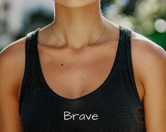 May include: A black tank top with the word "Brave" embroidered on the front.