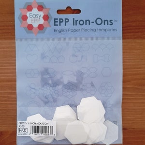 May include: A pack of 100 white 1/2 inch hexagon paper piecing templates for quilting. The pack includes the text "Easy EPP Iron-Ons" and "English Paper Piecing templates".
