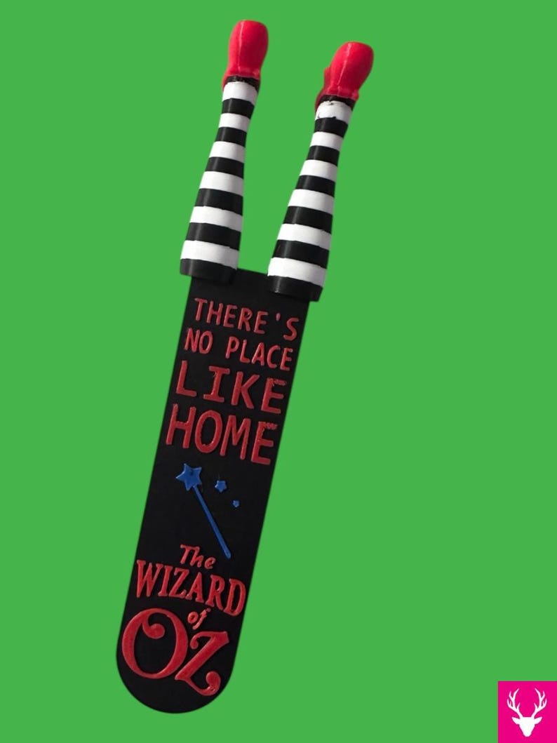 Wicked Witch Legs - striped black and white with Red Ruby Slippers.  Attached  to a bookmark reading " There's no place like home The Wizard of OZ"