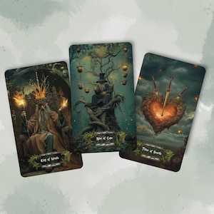 May include: Three tarot cards featuring fantasy art. The "King of Wands" card shows a regal figure. The "Nine of Cups" card depicts a figure in a tree. The "Three of Swords" card shows a heart pierced by swords.