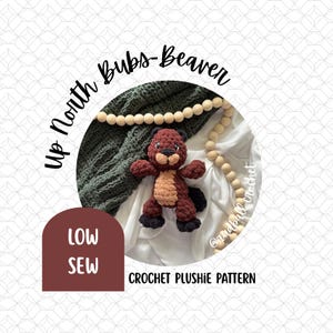 May include: A crochet plushie pattern for a beaver. The beaver is brown, tan, and black. The text "Up North Bubs-Beaver" is in a circle around the beaver. The text "LOW SEW" is in a maroon arch. The text "CROCHET PLUSHIE PATTERN" is below the beaver.
