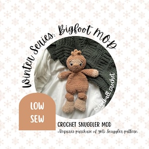 May include: A handmade brown and tan crochet Bigfoot plushie, part of the "Winter Series." The plushie has a textured body, small arms and legs, and a small head. The text "Bigfoot Mob" and "LOW SEW" are also visible.