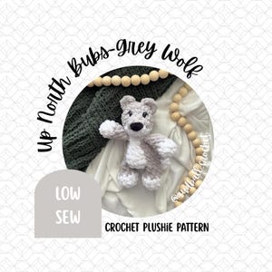 May include: A crocheted gray and white wolf plushie with black eyes and nose. The text "Up North Bubs-grey Wolf" is in a circular design. The words "Low Sew" are in a gray rounded rectangle. The text "CROCHET PLUSHIE PATTERN" is below the wolf.