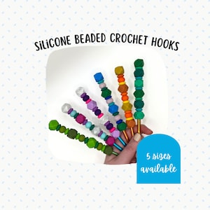 May include: Silicone beaded crochet hooks in various colors. The hooks have colorful geometric beads and gold-colored metal hook ends. The image includes the text "SILICONE BEADED CROCHET HOOKS" and "5 sizes available".