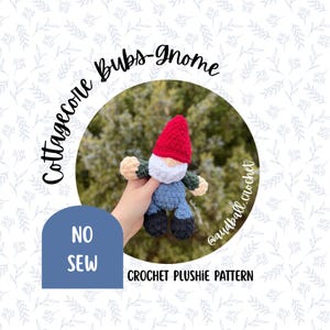 May include: A handmade crochet gnome plushie with a red hat, white beard, blue pants, and black shoes. The text "Cottagecore Bubs-gnome" and "NO SEW" are visible. The image also includes the text "CROCHET PLUSHIE PATTERN".