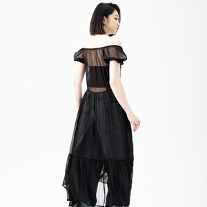 May include: A black sheer maxi dress with a ruffled hem and short puff sleeves. The dress is semi-transparent and has a fitted bodice.