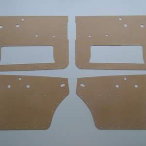 May include: Four beige cardboard panels with cutouts for a car door panel kit.