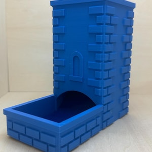 May include: A blue 3D printed dice tower shaped like a small castle with a brick pattern. The tower has a slot for dice to roll out of.