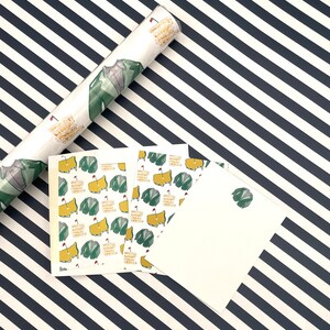 May include: A set of four gift tags featuring a green and yellow golf course design. The tags are printed on white cardstock and have a blank space for writing.