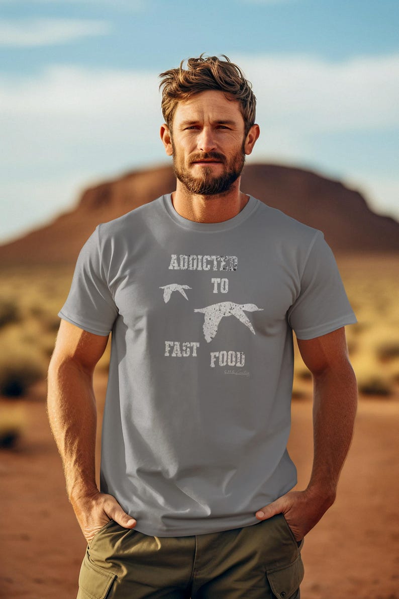 May include: A gray t-shirt with a white graphic that says "Addicted to Fast Food" with two stylized birds flying above the text.