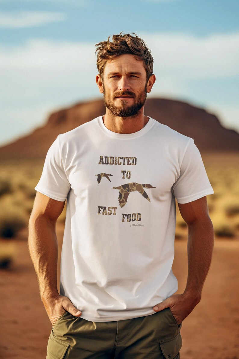 May include: White t-shirt with a camouflage print of ducks and the text "Addicted to Fast Food".