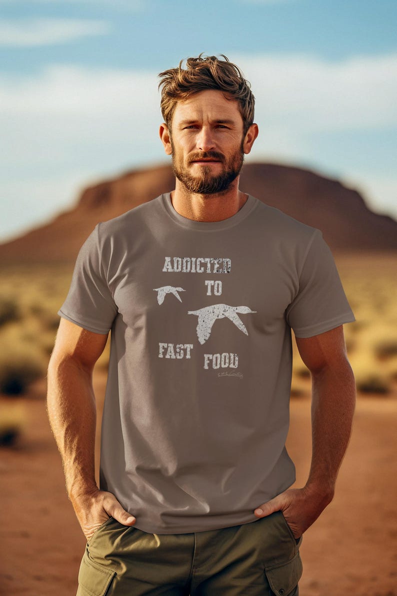 May include: A brown t-shirt with a white graphic that says "Addicted to Fast Food" with two stylized birds flying above the text.