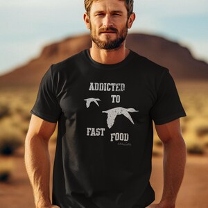 May include: A black t-shirt with a white graphic that says "Addicted to Fast Food" with a bird illustration.