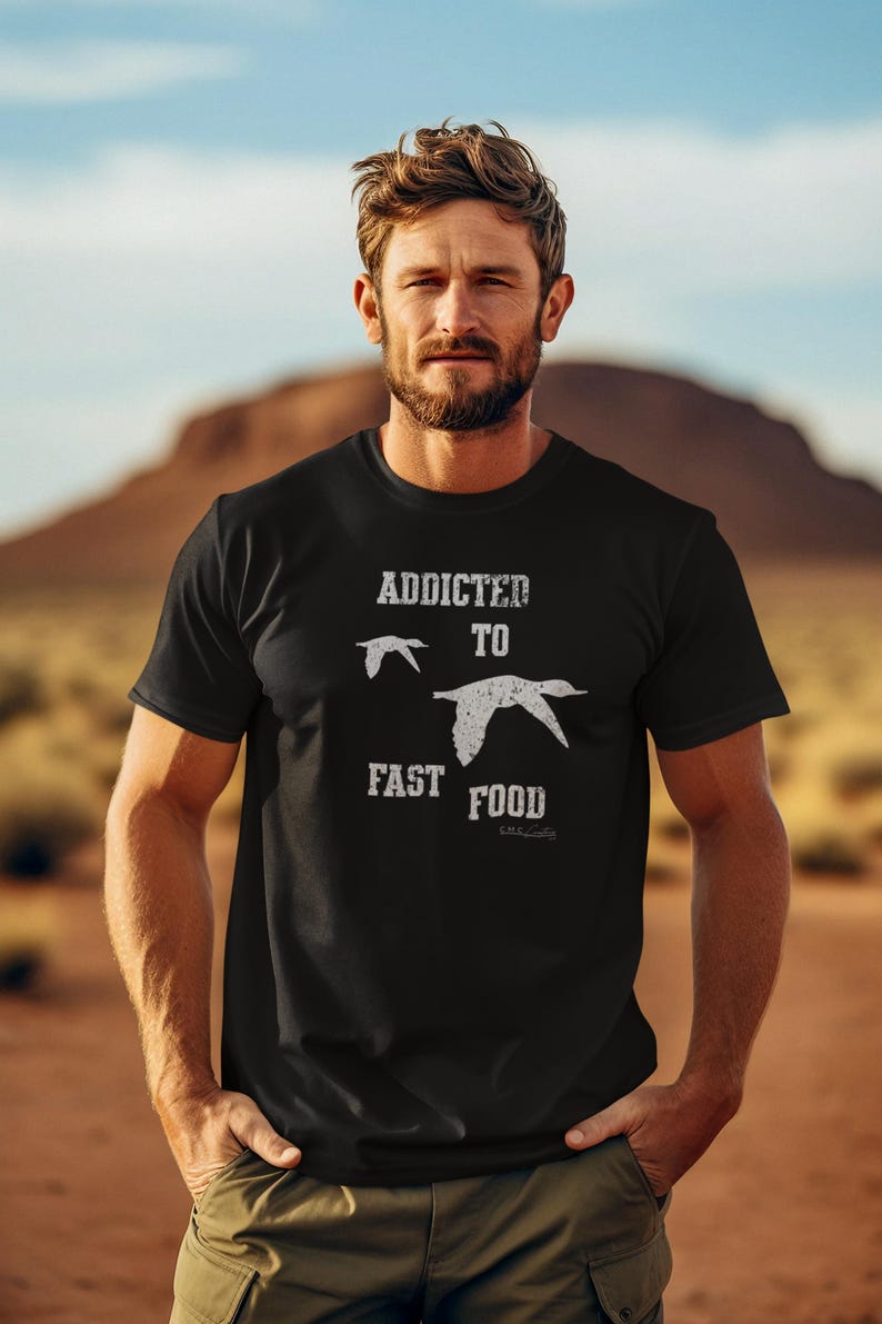May include: A black t-shirt with a white graphic that says "Addicted to Fast Food" with a bird illustration.