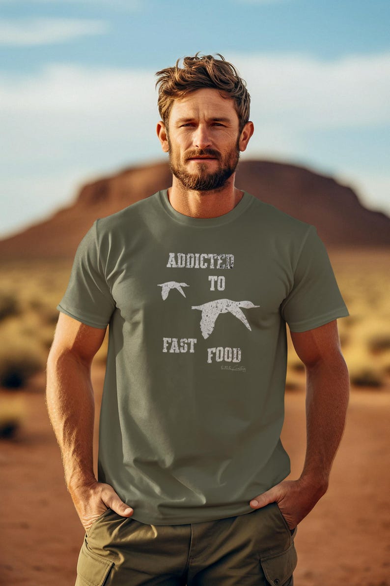 May include: A green t-shirt with a white graphic that says "Addicted to Fast Food" with a silhouette of a bird flying above the text.