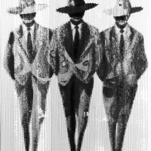 May include: Three men in suits and hats standing side by side. The men are wearing black suits and white shirts with black ties. The hats are black, white, and gray.