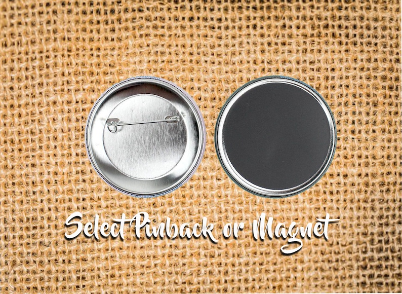 May include: Two round button badges, one with a pinback and the other with a magnet back. The text "Select Pinback or Magnet" is written in a cursive font. The background is a textured, tan fabric.