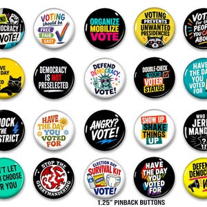 May include: A collection of twenty round 1.25-inch pinback buttons featuring various political and voting-themed slogans, colorful graphics, and illustrations including a cat, a raccoon, the Statue of Liberty, a dragon, and a coffee mug.