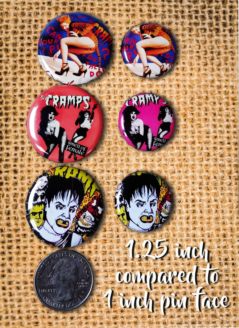 May include: A collection of six round pinback buttons with various designs. The buttons feature images of women, the band "The Cramps", and text. The size is 1.25 inches compared to 1 inch pin face.