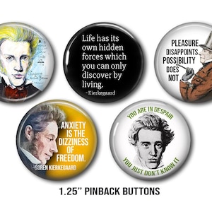 May include: A collection of five 3.18 cm pinback buttons. Each button displays a portrait and a quote. The buttons feature quotes by Kierkegaard, including "Life has its own hidden forces" and "Anxiety is the dizziness of freedom."