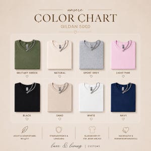 May include: Color chart featuring eight folded t-shirts in various colors: military green, natural, sport grey, light pink, black, sand, white, and navy. Each shirt has a silver chain detail at the neckline. The text "COLOR CHART" is at the top.