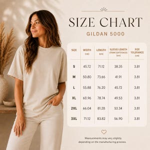 May include: A beige t-shirt size chart for the Gildan 5000 model. The chart displays measurements in centimeters for sizes S through 3XL, including width, length, sleeve length from center back, and a size tolerance of 3.81 cm for each size.