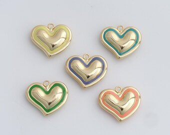 May include: Five gold-colored heart-shaped charms with colorful enamel borders. The charms have a glossy finish and are accented with green, blue, yellow, and coral enamel. Each charm has a small loop at the top for attaching to jewelry.